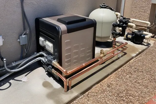 Pool heater and filtration equipment on a concrete slab at a residential worksite in Phoenix, AZ.