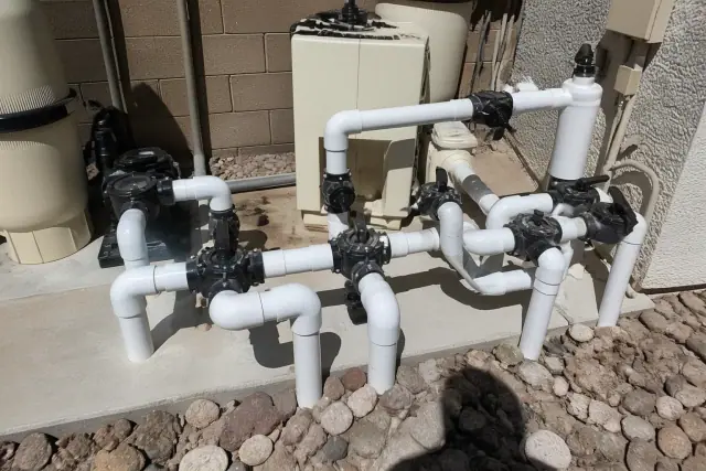 New PVC plumbing and valves on a pool equipment pad at a jobsite in Phoenix, AZ.