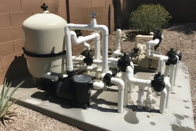 Pool pump and circulation system with new PVC fittings and pressure gauge at a home in Phoenix, AZ.