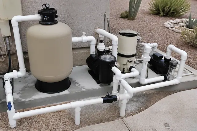 Pool pumps and filtration system installed on a concrete slab in Phoenix, AZ.