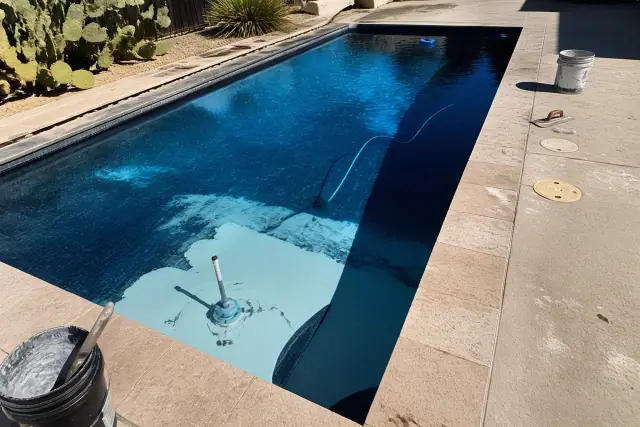 Technician applying underwater epoxy to repair a residential swimming pool in Phoenix, AZ.
