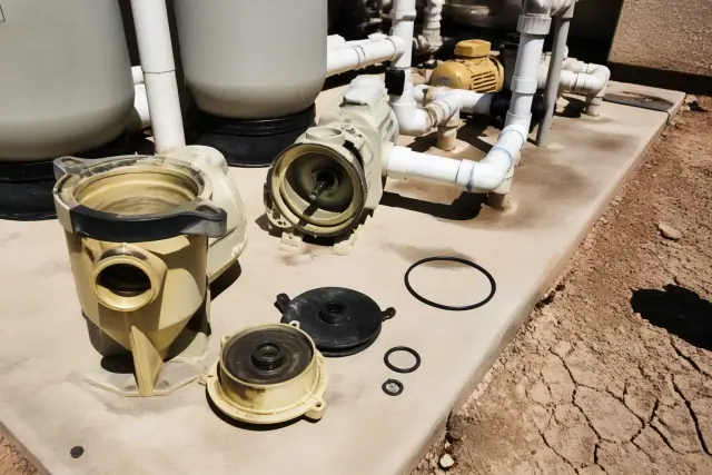 Pool pump seal and gasket replacement in progress on a concrete equipment pad in Phoenix, AZ.