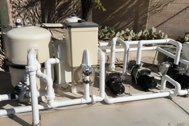 New pool equipment installation with PVC plumbing and chemical feeder at a home in Phoenix, AZ.