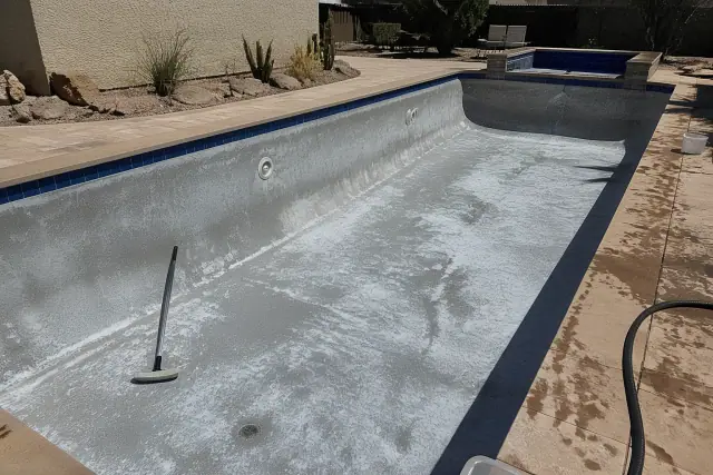 Residential swimming pool in Phoenix, AZ after a standard plaster acid wash showing cleaned surfaces and desert landscaping.