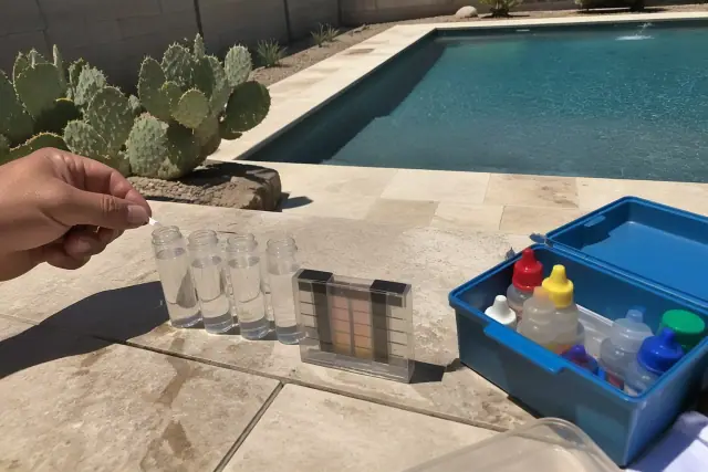 Testing four core water levels in a residential pool in Phoenix, AZ, with prickly pear cactus in the background.