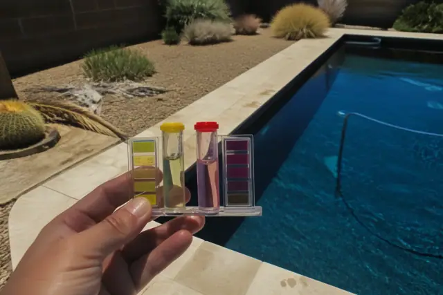 Technician testing water with reagent vials by a swimming pool on a sunny day in Phoenix, AZ.