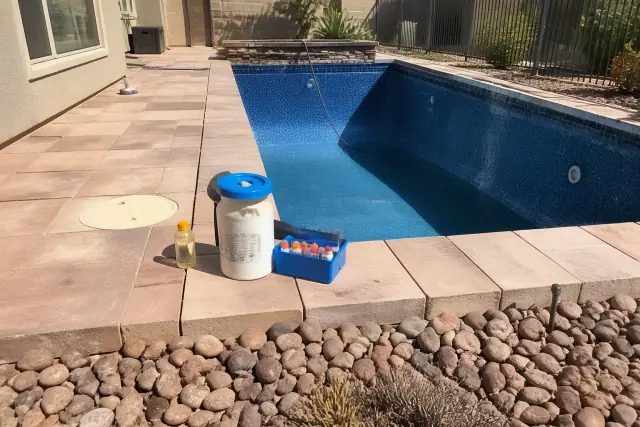 A partially drained swimming pool undergoing an acid wash service in a Phoenix, AZ backyard.