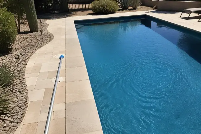 Pool technician performing a weekly water care visit at a residential backyard pool in Phoenix, AZ.