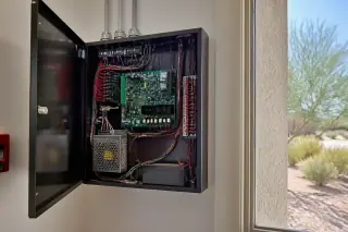 Interior view of a finalized fire alarm control panel cabinet with organized wiring at a Phoenix, AZ jobsite.