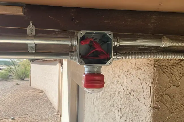 Electrical conduit and fire-rated cabling installed on an unfinished ceiling at a job site in Phoenix, AZ.