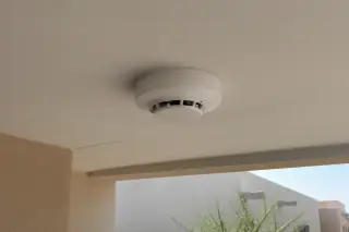 High-sensitivity smoke detector mounted on a commercial ceiling in Phoenix, AZ.