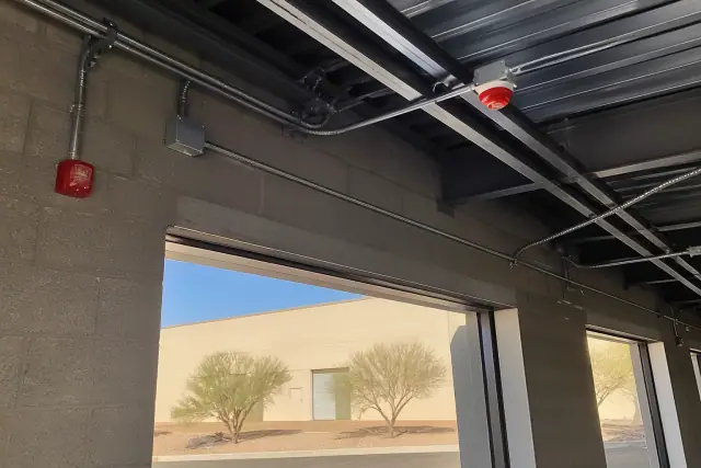 Industrial fire detection installation with conduits and heat detectors in a Phoenix, AZ warehouse.