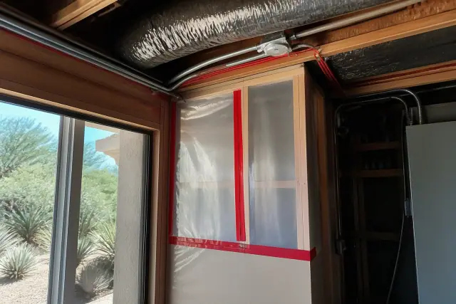 Exclusion zone barriers installed on an unfinished ceiling with exposed electrical wiring in a Phoenix, AZ home.