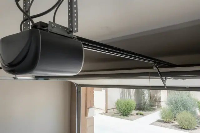 Belt-drive garage door opener motor and rail installed on a ceiling in Phoenix, AZ.