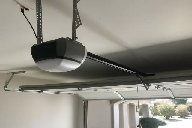 Belt-drive garage door opener motor mounted to a ceiling in Phoenix, AZ.
