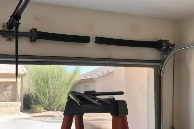Broken garage door spring with a gap in the coil visible in a home garage in Phoenix, AZ.