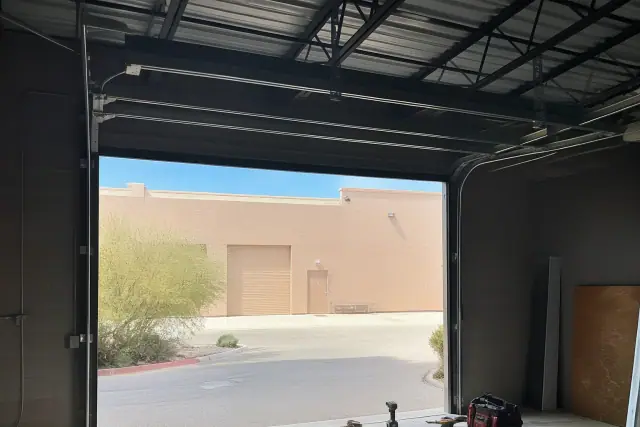 Commercial garage door repair in progress at an industrial warehouse bay in Scottsdale, AZ.