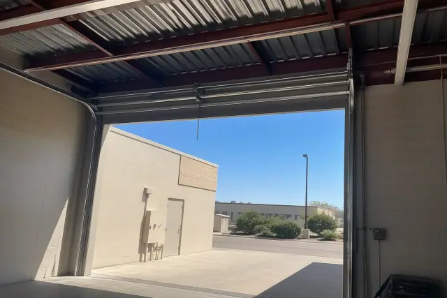 Commercial garage door high-lift track system installed on a warehouse bay in Mesa, AZ.