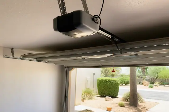 Commercial garage door opener motor mounted to the ceiling at a job site in Phoenix, AZ.