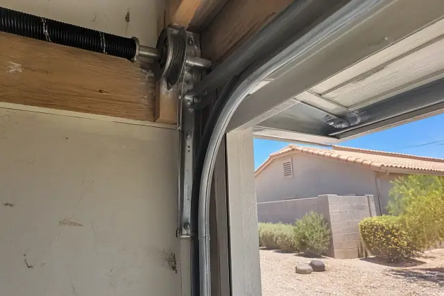 New high-tension steel garage door cable installed on a residential track in Avondale, AZ.