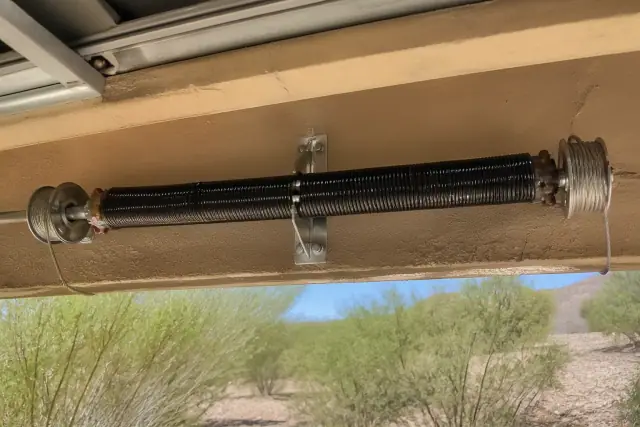 Torsion springs and cables on a garage door being serviced in Goodyear, AZ.