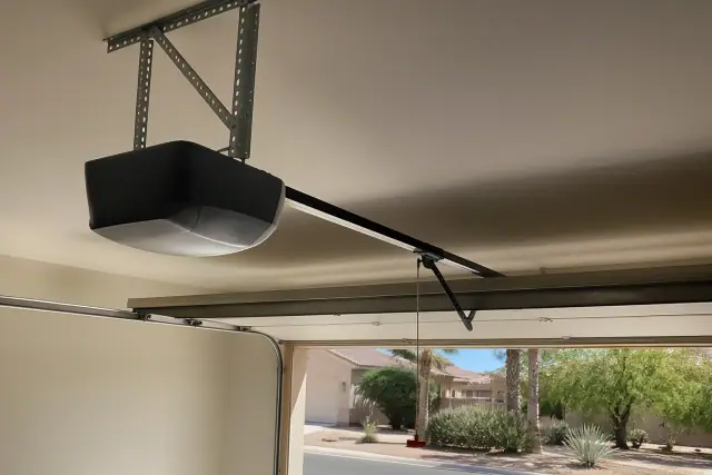 New garage door opener motor and rail installed on a ceiling in a Mesa, AZ home.