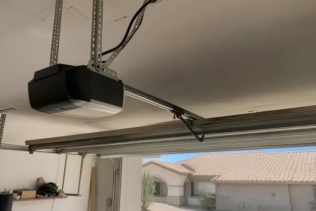 Garage door opener motor installed on a residential garage ceiling in Phoenix, AZ.