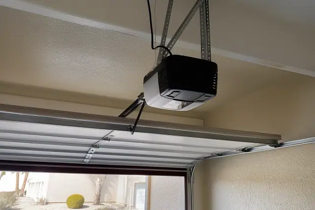 Garage door opener motor installed on the ceiling of a garage in Chandler, AZ.