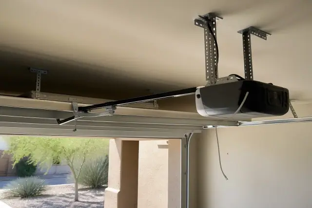 Newly installed garage door opener motor and ceiling brackets at a home in Gilbert, AZ.