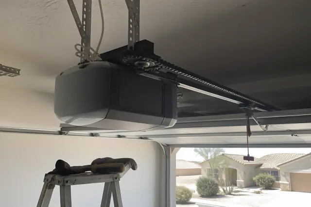 Garage door opener motor and new drive chain installed on a residential ceiling in Surprise, AZ.