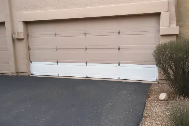 A garage door with a new bottom panel installed at a residential home in Peoria, AZ.