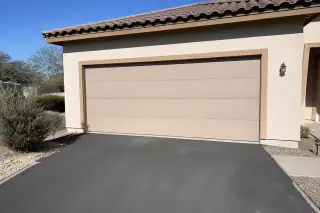 Closed residential garage door with new horizontal panels at a home in Phoenix, AZ.