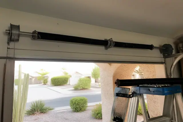 Torsion springs and cable drums on a garage door being repaired in Phoenix, AZ.