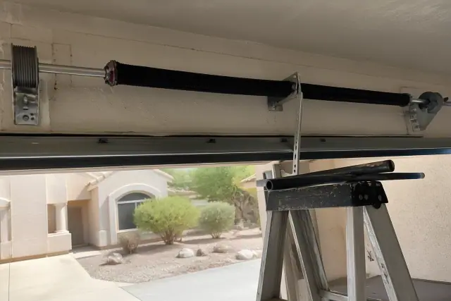 New torsion spring and hardware installed on a garage door in Tempe, AZ.