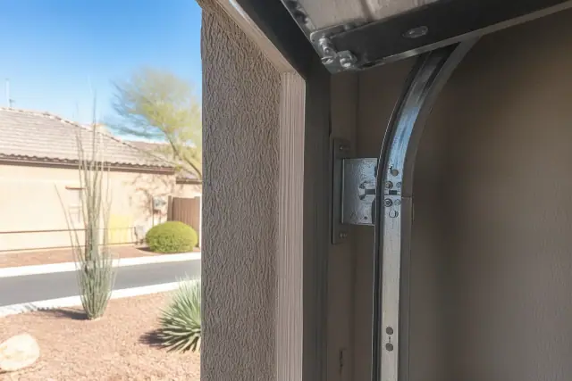 Garage door track and roller upgrade on a stucco home in Phoenix, AZ.