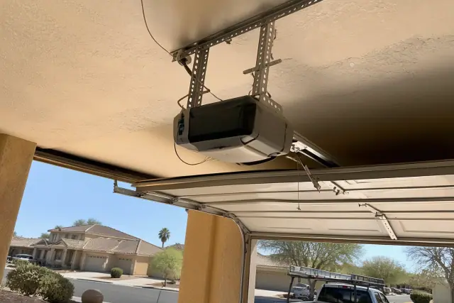 Heavy-duty garage door opener motor mounted to a ceiling in Phoenix, AZ.