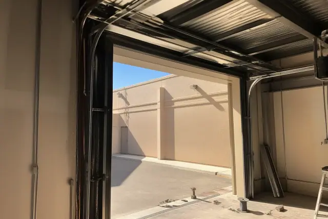 High-lift garage door cable repair on a commercial track system at a building in Phoenix, AZ.