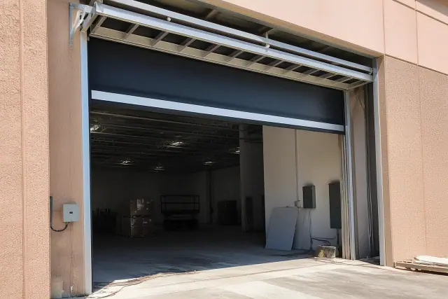 High-speed commercial warehouse doors installed on a metal track system at a facility in Phoenix, AZ.