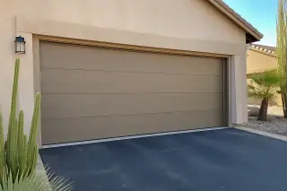 Closed garage door with horizontal panels on a stucco home in Phoenix, AZ.