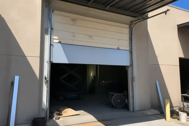 Commercial garage door panel and roller replacement at an industrial building in Phoenix, AZ.