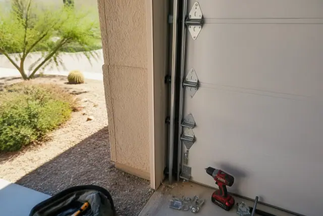 Garage door roller and hinge replacement in progress at a residential property in Phoenix, AZ.