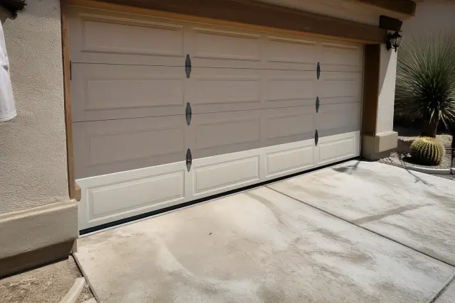 New single garage door panel replacement on a house with xeriscaping in Phoenix, AZ.