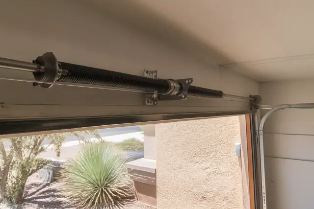 New torsion springs and cables installed on a garage door header in Phoenix, AZ.