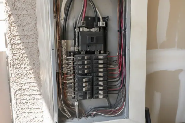 Electrical panel upgrade in Phoenix, AZ showing a new main breaker and copper wires.