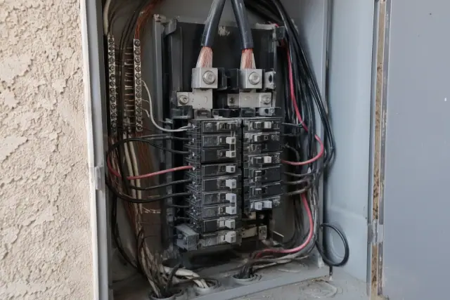 Open electrical panel showing copper branch wiring and switches in Phoenix, AZ.
