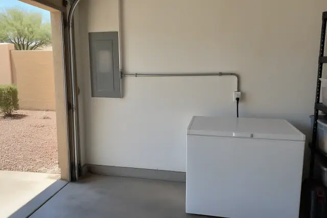 Surface raceway running to a single receptacle by a freezer in a Phoenix, AZ garage.