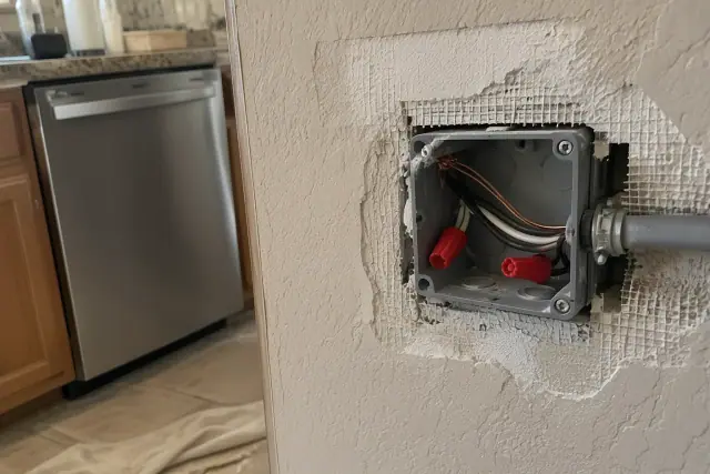 Dedicated dishwasher circuit wiring inside a wall junction box in Phoenix, AZ.