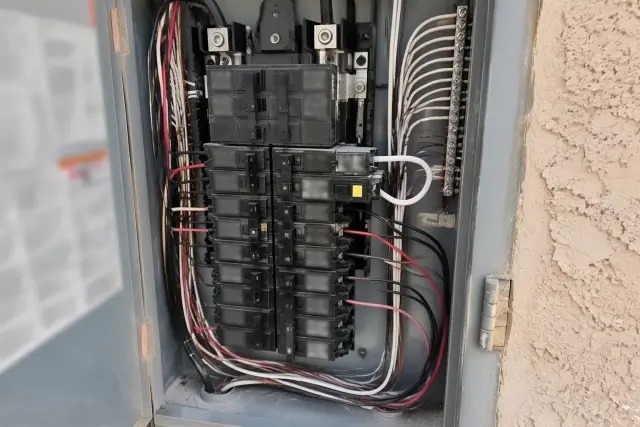 Open electrical service panel with a dual-function AFCI/GFCI breaker in Phoenix, AZ.