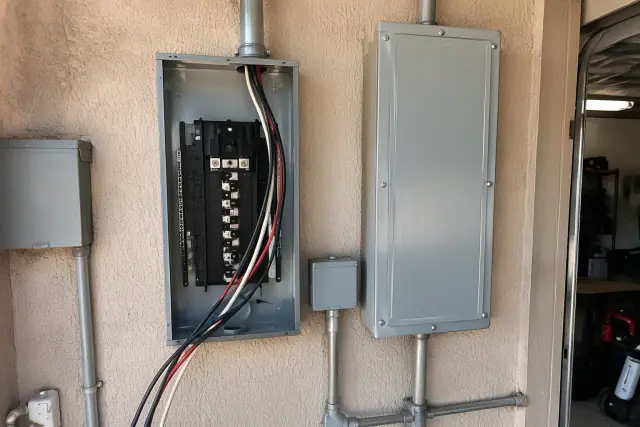 Contractor photo of an electrical panel upgrade with new conduit in Phoenix, AZ.