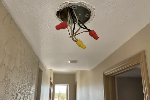 Open ceiling junction box with exposed wires during an electrical troubleshooting job in Phoenix, AZ.